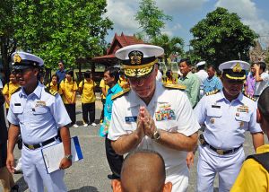 U.S. Navy Rear Adm. Thomas Carney returns a boy's traditional Thai greeting
