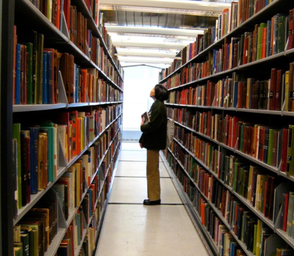 A person peruses bookstacks at the Minneapolis Public Library.