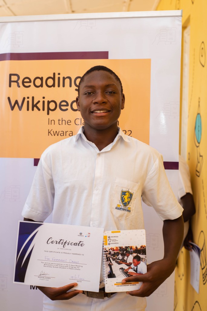GSSI Kwara RWC Student holding his certificate and RWC Student Guide
