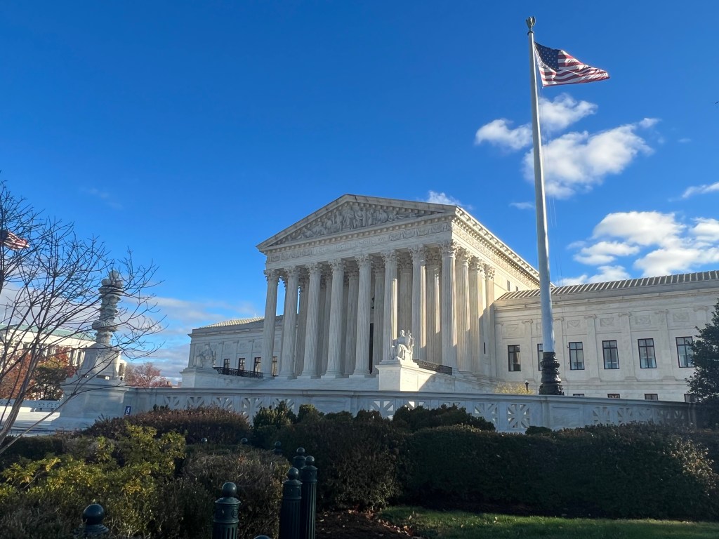 A photograph of the United States Supreme Court building on a sunny day